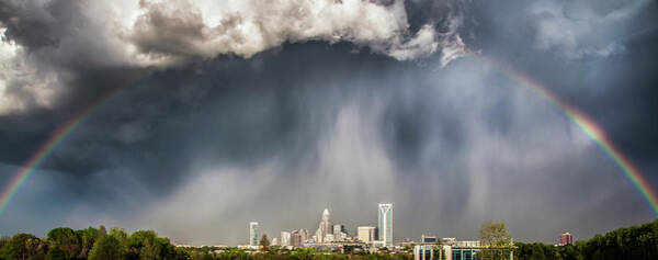Cityscape Beneath a Dark Sky and Rainbow Wall Art