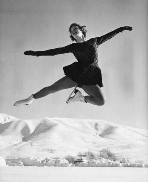 Elegant Ice Skating Leap in Snowy Landscape Wall Art