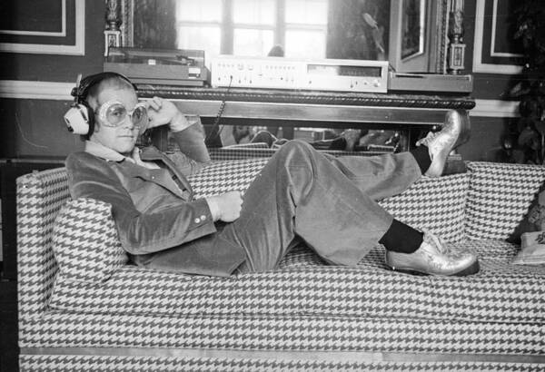 Elton John Relaxing on Couch Wall Art