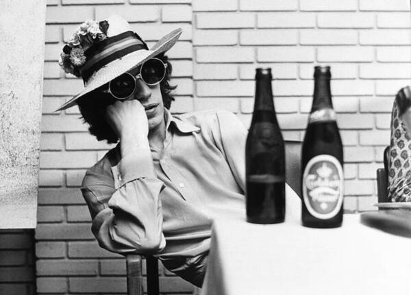Flower Wall Art featuring the photograph Portrait Of Mick Jagger With A Sun Hat by Keystone-france
