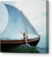 Woman Sailing on a Traditional Boat Canvas Print by Franco Rubartelli