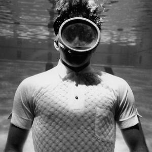 A Male Model Underwater In A Pool With A Scuba by Leonard Nones