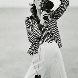 A Model Looking Through A Beaulieu Camera Wearing by Gianni Penati