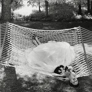 A Model Lying On A Hammock by Gene Moore A Model Lying On A Hammock by Gene Moore