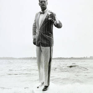 A Model Stands In The Surf In Bronzini by Richard Waite