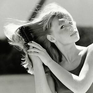 Model Brushing Her Hair by Mike Reinhardt