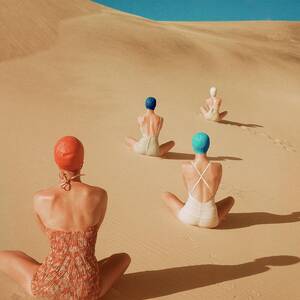 Models Sitting On Sand Dunes by Clifford Coffin