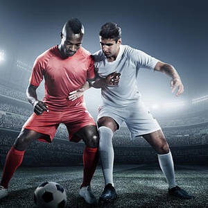 Soccer Player Kicking Ball In Stadium by Dmytro Aksonov