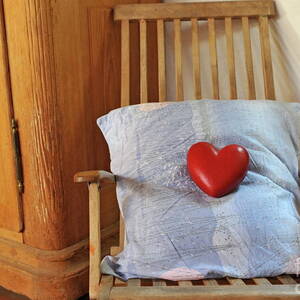 Heartshape and pillow on wooden rocking chair by Sami Sarkis Photography