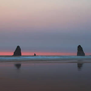 Cannon Beach and Haystack Rock Sunset with a smokey sky by Bruce Block
