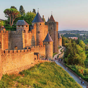 France, Occitanie, Carcassonne, Aude, The Medieval Fortified City With Its Walls, Towers And Castle Illuminated By The Warm Sunset Light by Luigi Vaccarella France, Occitanie, Carcassonne, Aude, The Medieval Fortified City With Its Walls, Towers And Castle Illuminated By The Warm Sunset Light by Luigi Vaccarella