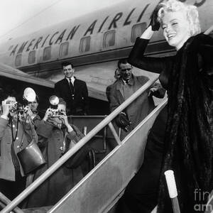 Marilyn Monroe Boards Airplane by Bettmann