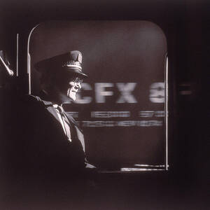 Train Conductor Looking Out Of Window by John Coletti