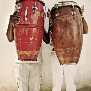 Two Men Holding Bongos In Front Of by Holly Wilmeth Two Men Holding Bongos In Front Of by Holly Wilmeth