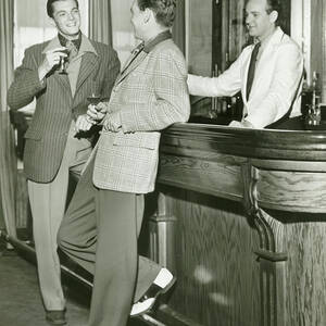 Two Men Talking At Bar Counter by George Marks