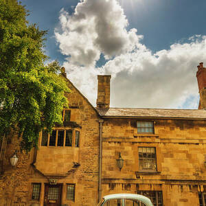 United Kingdom, England, Gloucestershire, Great Britain, Cotswolds, British Isles, Chipping Campden, An Old Car In Front Of A Traditional House In Chipping Campden On A Sunny Summer Afternoon by Maurizio Rellini