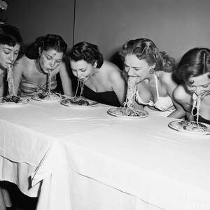 Women In A Spaghetti Eating Contest by Bettmann