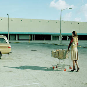 Young Woman Pushing Trolly Full Of by Kelvin Murray Young Woman Pushing Trolly Full Of by Kelvin Murray
