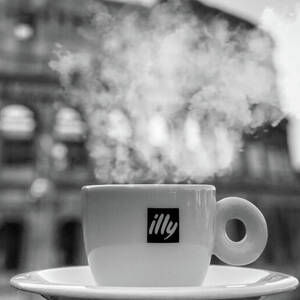 A cup of black coffee in front of Colosseum in Rome by Stefano Senise