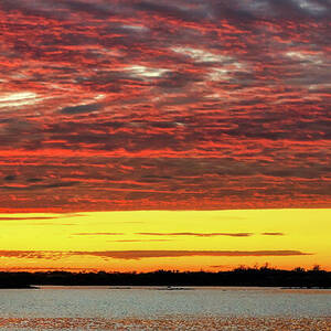 Vibrant Sunset Over Tranquil Lake by Bruce Block